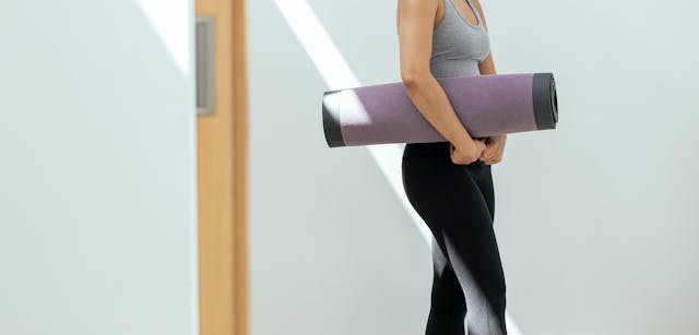 Woman carrying acupressure mat